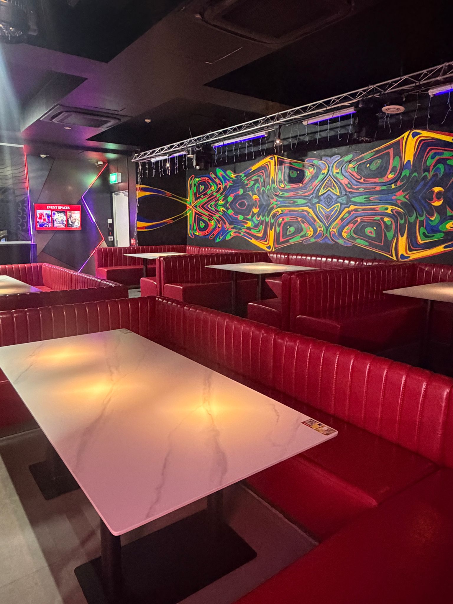 Modern bar interior with colorful wall display in Clarke Quay.