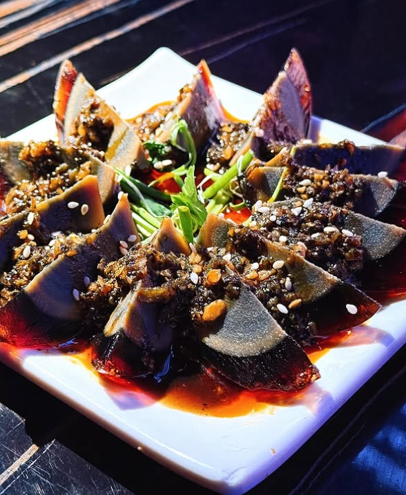 Plated dish of century eggs on white plate n a Bar at Clarke Quay.