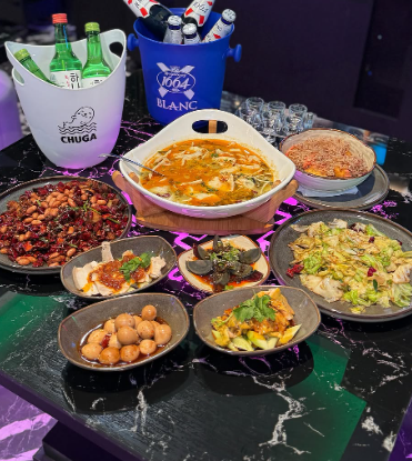 Assorted dishes on a table with drinks in a bar at Clarke Quay.