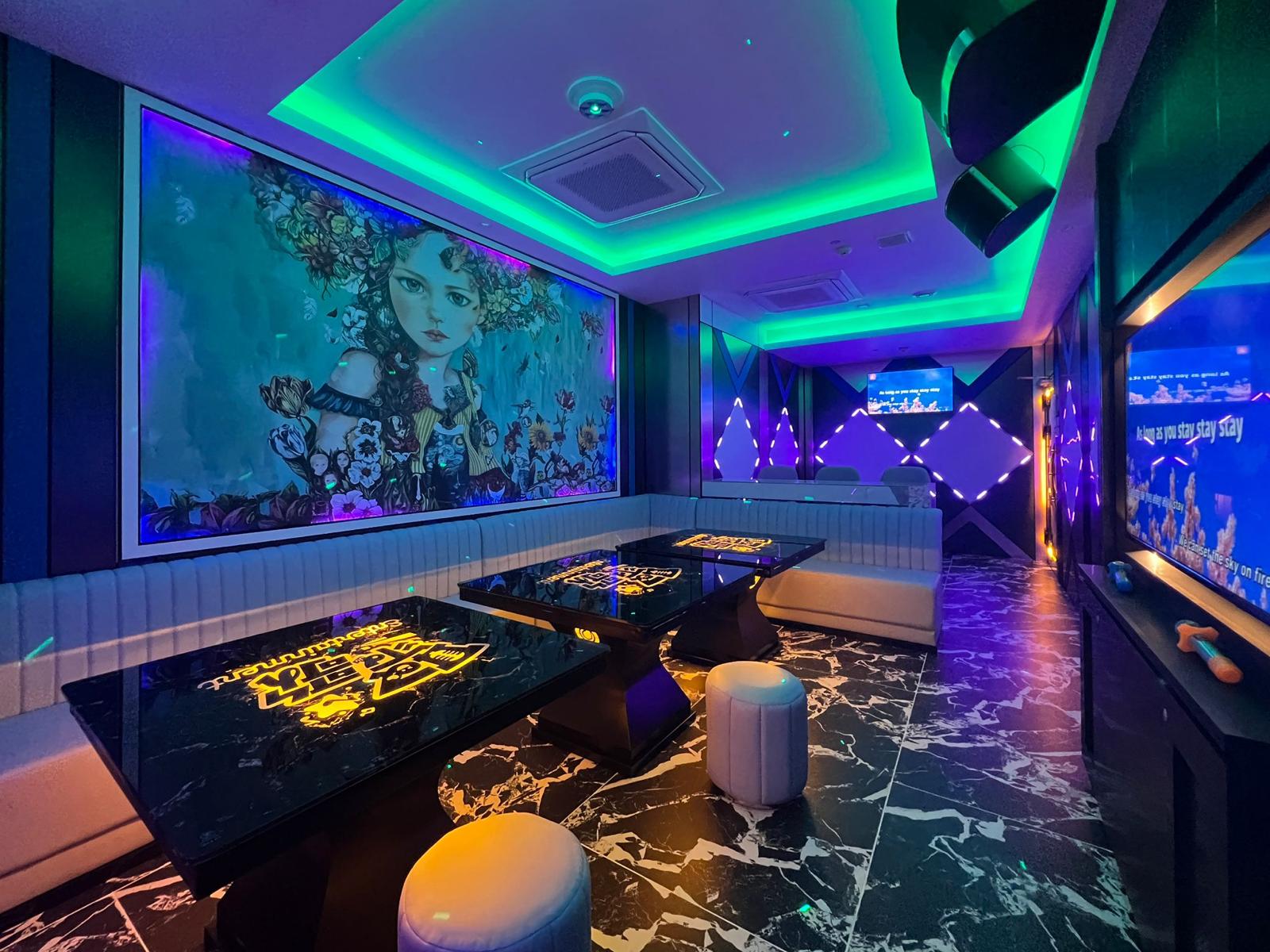 Modern interior design with colorful lighting, marble flooring, and artistic wall decorations in Clarke Quay.