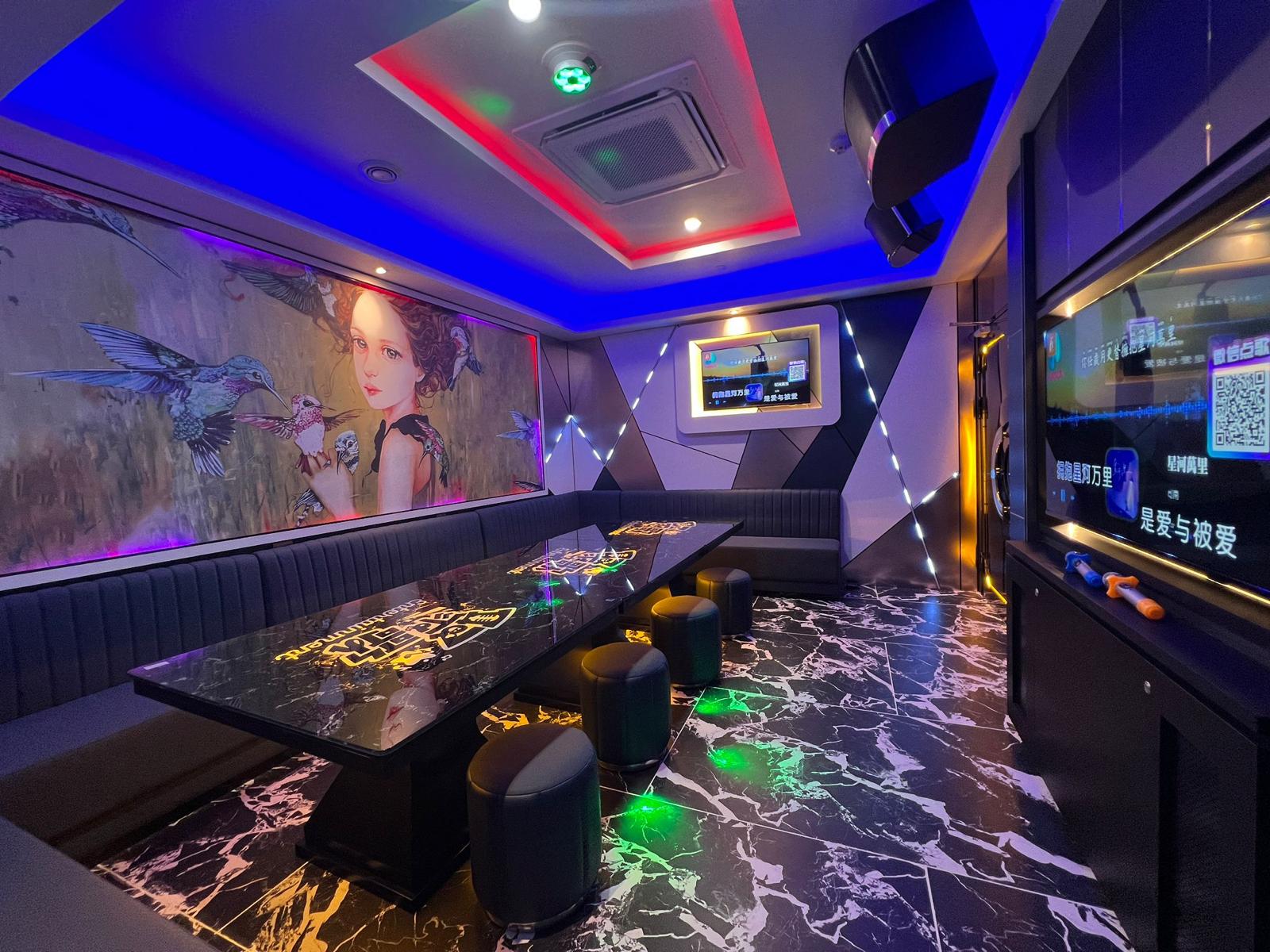 Modern interior design with a bar area, colorful lighting, and artwork on the walls in Clarke Quay.