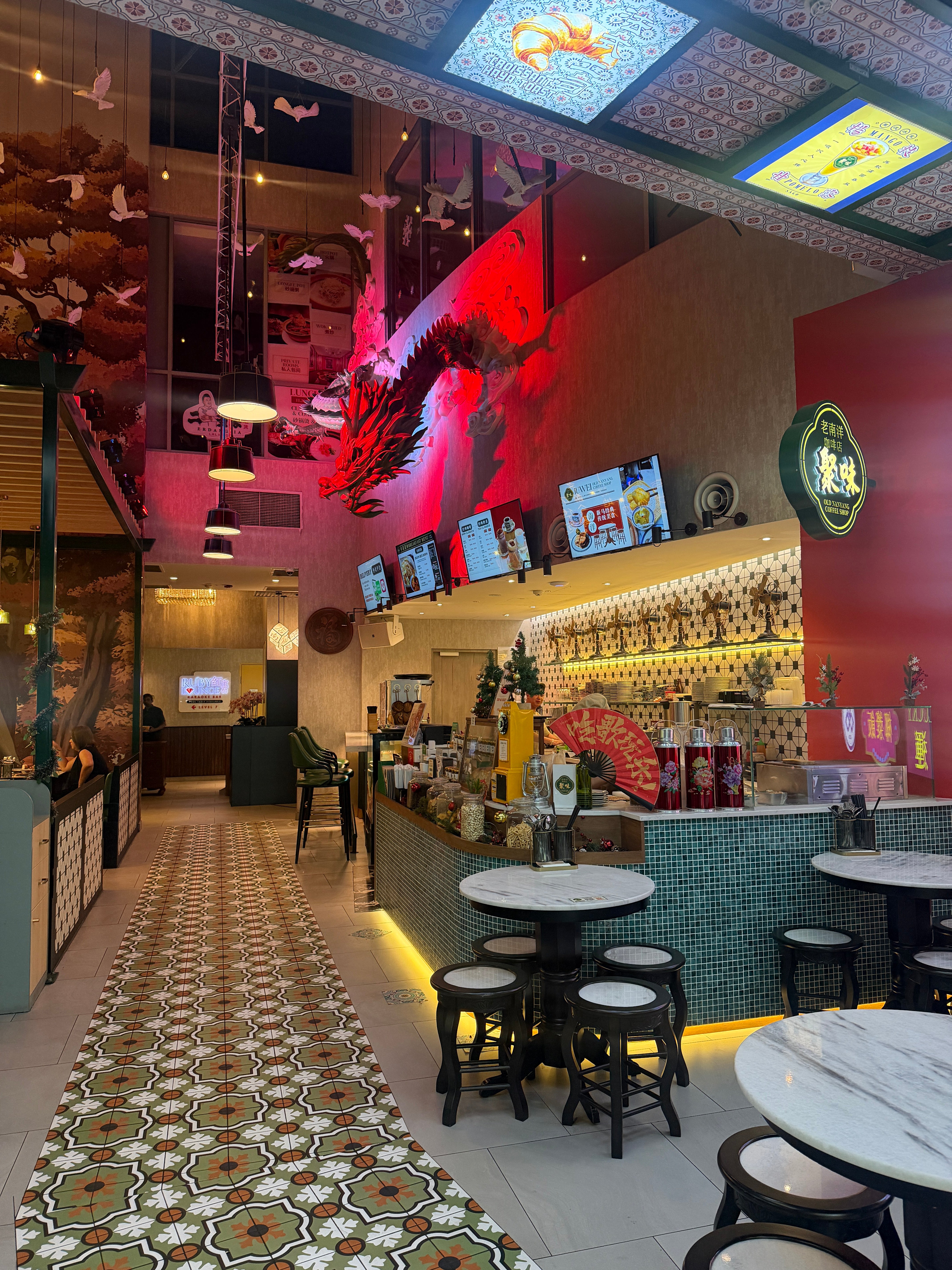 Interior of a nanyang restaurant with tables, chairs, and decorative elements.